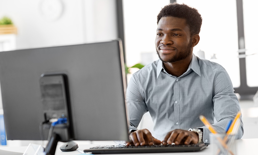 Man typing on computer.